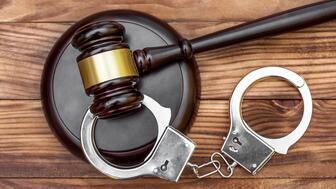 Authorities have arrested and indicted four men allegedly tied to 43 home burglaries, stealing jewelry and other valuables from mainly Indian and South Asian families in Massachusetts. Stock image of handcuffs and gavel