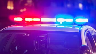 Authorities have arrested and charged a man in connection with multiple armed robberies, including one at a jewelry store in Queens, New York. Stock image of police car with lights on