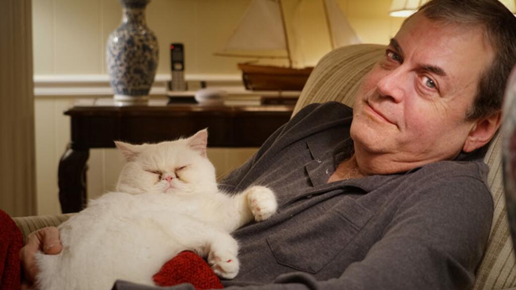 Brian Mann with the family’s rescue cat, Sweetpea. The longtime Washington, D.C. jeweler loved cats, as well as collecting watches and watching movies. Brian Mann with his cat, Sweetpea