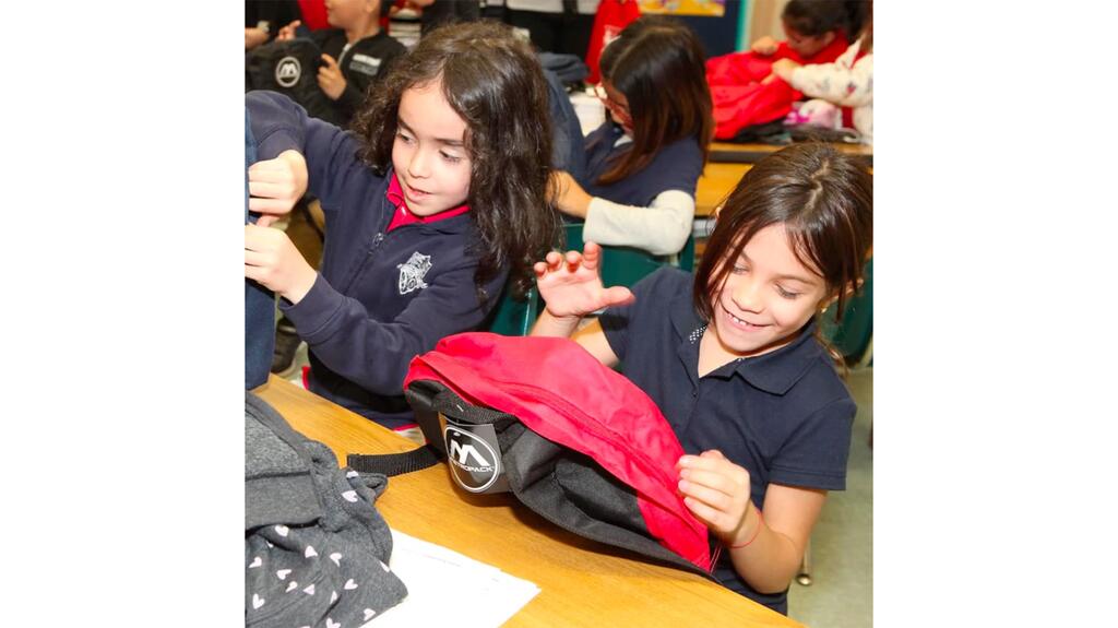 Shane Co. and KINF donated backpacks to 6,000 students in 13 states last year. Students receiving donated backpacks