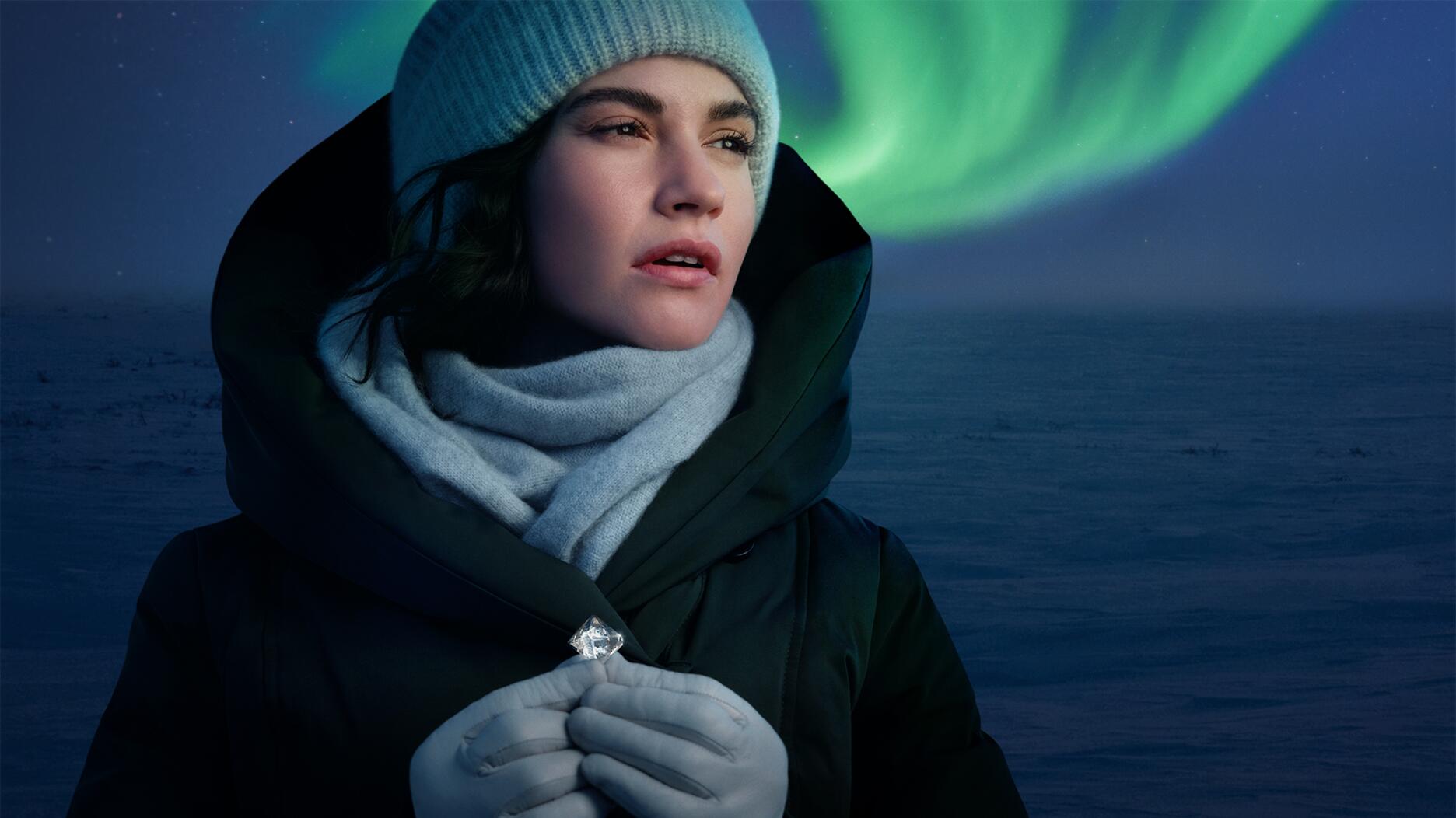 The Natural Diamond Council’s new “Real. Rare. Responsible” campaign starring actress and NDC ambassador Lily James (“Cinderella,” “Downton Abbey”) was shot in Canada’s Northwest Territories, where the Northern Lights are visible more than half the year. (Photo courtesy of the Natural Diamond Council) Actress Lily James with a rough diamond and the Northern Lights