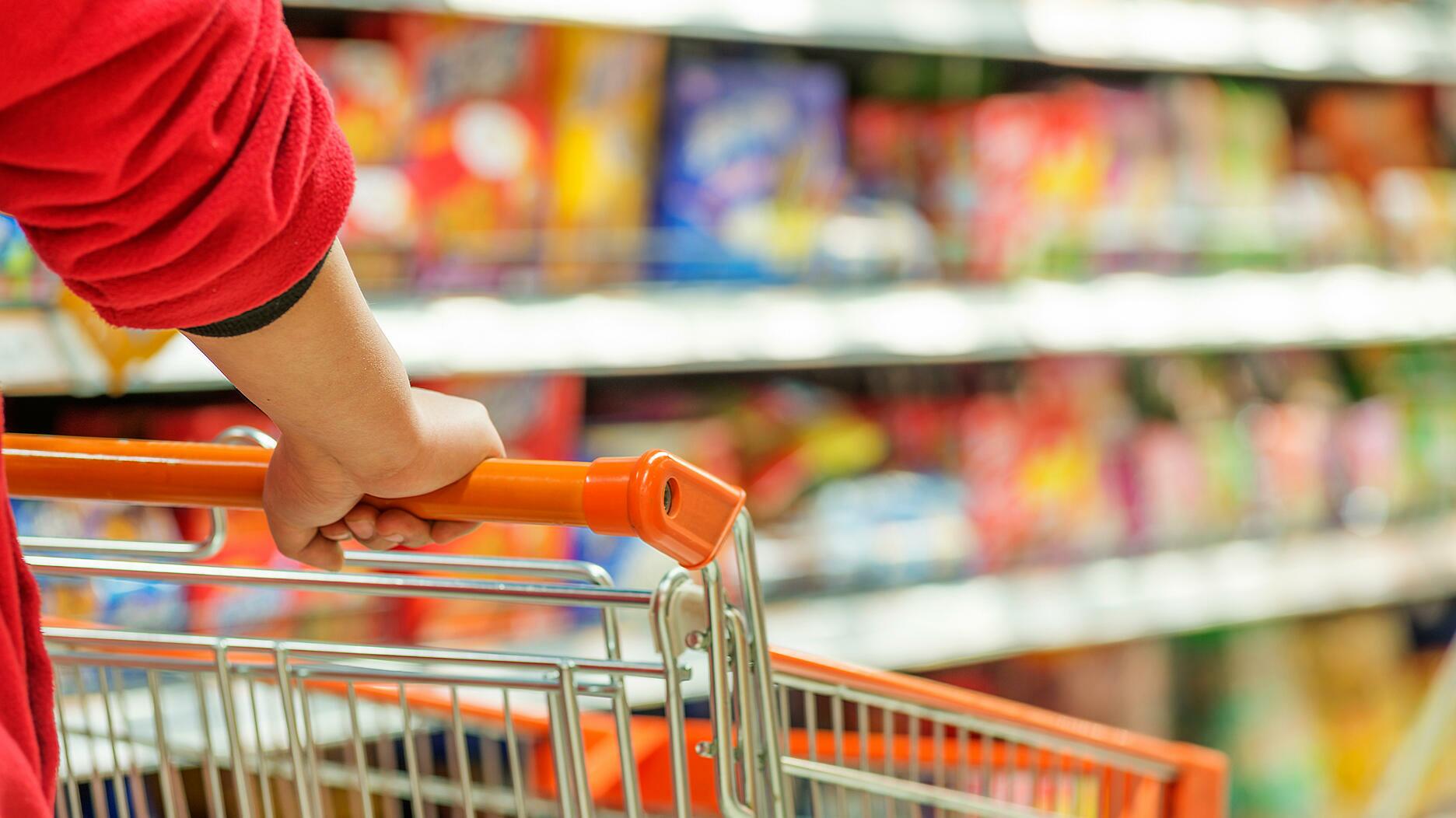 The Conference Board’s consumer confidence index fell to 103 in September from 108.7 in August. Hands pushing a shopping cart