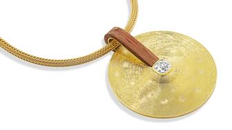 From Jade Ruzzo’s “Percussion” collection, this “Cymbal Pendant” is rendered in 18-karat yellow gold with a 1.56-carat old mine-cut diamond and Brazilian rosewood ($15,800). The designer has a penchant for antique diamonds. Jade Ruzzo jewelry Percussion collection Cymbal pendant