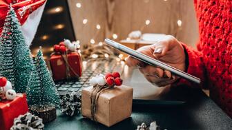 The National Retail Federation predicted that a record-breaking 182 million consumers will shop both online and in-store over the holiday weekend. Holiday shopping at laptop