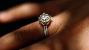 De Beers Group’s latest round of rough diamond sales totaled $380 million, down 21 percent year-over-year. The company expects natural diamond sales to remain challenging in the near future but anticipates an uptick in engagements in the coming years. (©De Beers Group/Photo credit: Ben Perry @ Armoury Films) Stock image of a diamond engagement ring