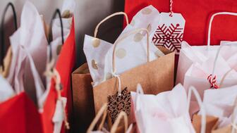 Shoppers are expected to spend $875 on average celebrating winter holidays this year, up from $833 last year, according to the National Retail Federation’s latest consumer survey, conducted by Prosper Insights & Analytics. Stock image of holiday gifts in bags