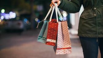 Retail sales, excluding sales at gas stations, restaurants, and car dealerships, were up 3.8 percent year-over-year during the 2023 holiday season and rose 3.6 percent for the full year, the NRF said last week. Stock image of hand holding holiday shopping bags