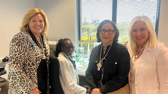 Signet Jewelers CEO Gina Drosos (left), CFO Joan Hilson, and Group President and Chief Consumer Officer Jamie Singleton are seen here with a factory employee during a recent trip to Botswana. Gina Drosos, Joan Hilson, and Jamie Singleton