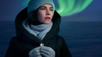 The Natural Diamond Council’s new “Real. Rare. Responsible” campaign starring actress and NDC ambassador Lily James (“Cinderella,” “Downton Abbey”) was shot in Canada’s Northwest Territories, where the Northern Lights are visible more than half the year. (Photo courtesy of the Natural Diamond Council) Actress Lily James with a rough diamond and the Northern Lights