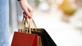 The Conference Board’s consumer confidence index fell to 102.3 in May from 103.7 in April. A hand holding shopping bags