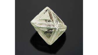 This 7.42-carat light bluish-green synthetic moissanite, submitted as a diamond, displays triangular features on each of the octahedral faces. (Photo credit: Jian Xin (Jae) Liao.) 20221117_GIA-snyth-moissanite.jpg
