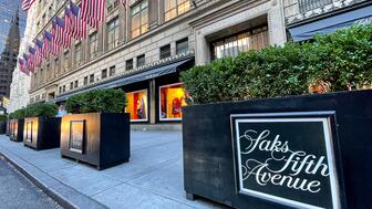 Pictured is Saks Fifth Avenue’s New York City store. The company has laid off around 100 employees as its parent company, HBC, prepares to acquire Neiman Marcus Group. Saks Fifth Avenue New York City store