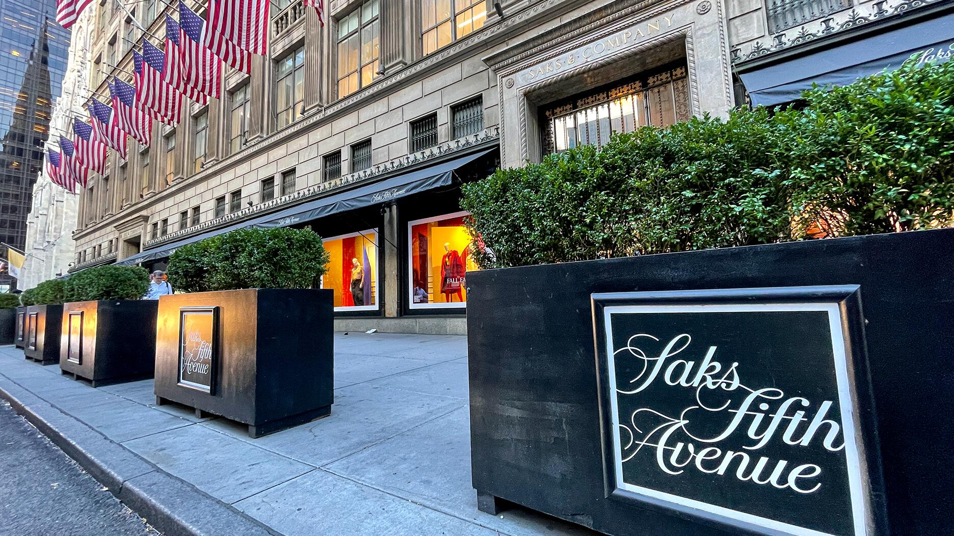 Pictured is Saks Fifth Avenue’s New York City store. The company has laid off around 100 employees as its parent company, HBC, prepares to acquire Neiman Marcus Group. Saks Fifth Avenue New York City store