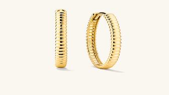 A pair of 14-karat gold hoops by Mejuri, available in four sizes and crafted with “Salmon Gold.” The retailer is partnering with Resolve, an organization that supports biodiversity and habitat rehabilitation of sites where mining once took place. Mejuri salmon gold hoop earrings